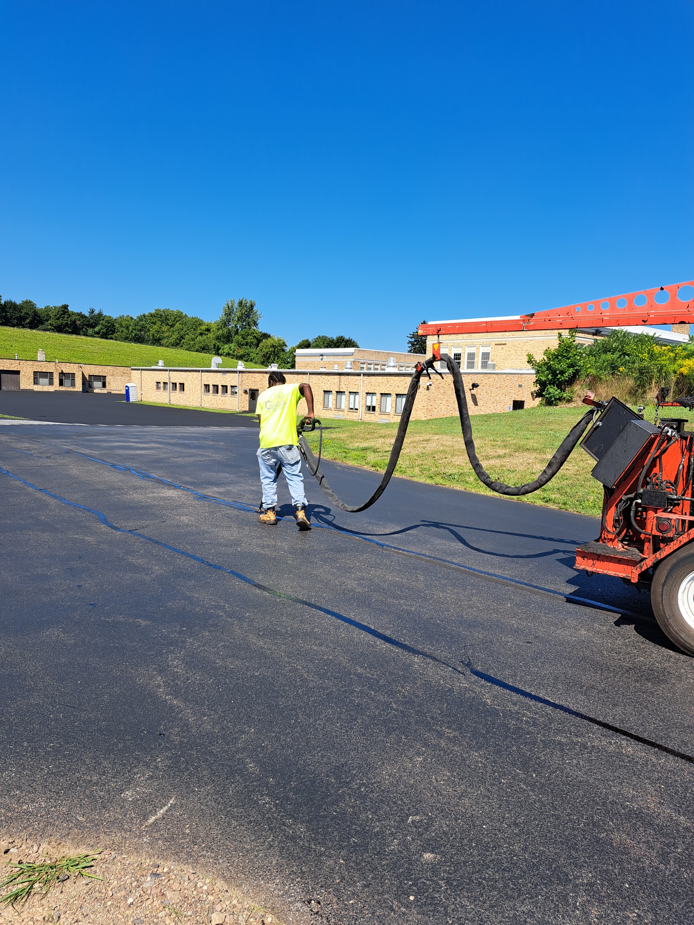 Champion Asphalt crack filling truck on job site